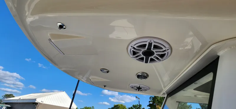 Slide: The Image of 2025 ShearWater 270 SS Open Carolina boat ceiling with speakers and blue sky background. - 22