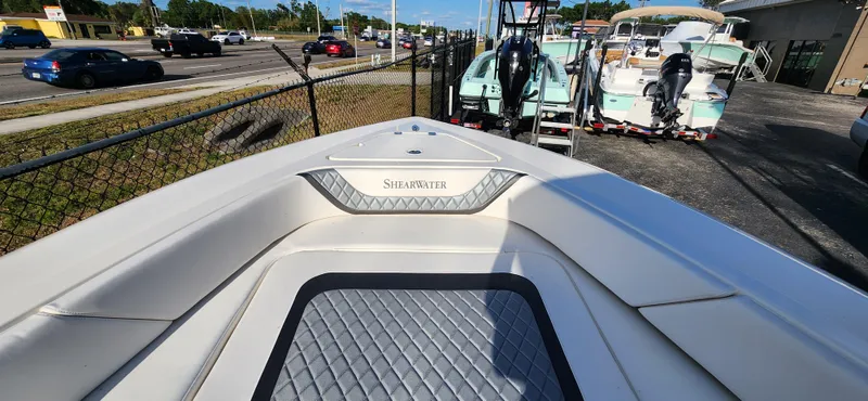 Slide: The Image of 2025 ShearWater 270 SS Open Carolina boat, parked near a road with other boats. - 26