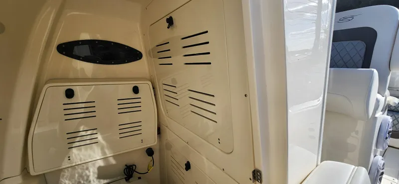Slide: The Image of 2025 ShearWater 270 SS Open Carolina boat interior with storage compartments. - 29