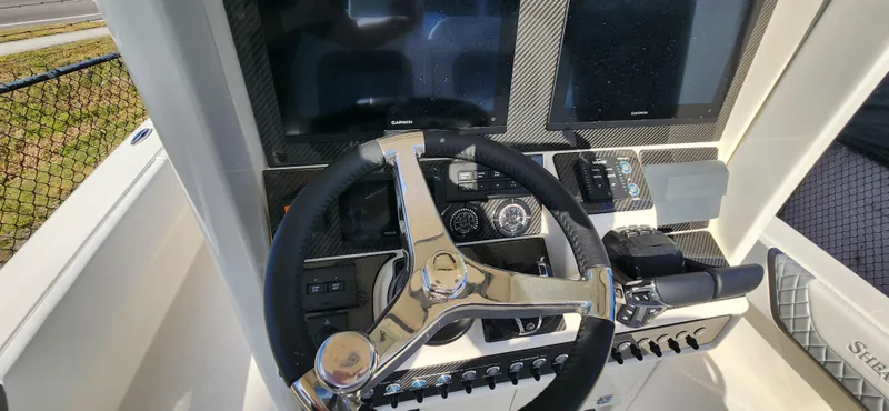 Slide: The Image of Steering console of 2025 ShearWater 270 SS Open Carolina boat with dual screens. - 30