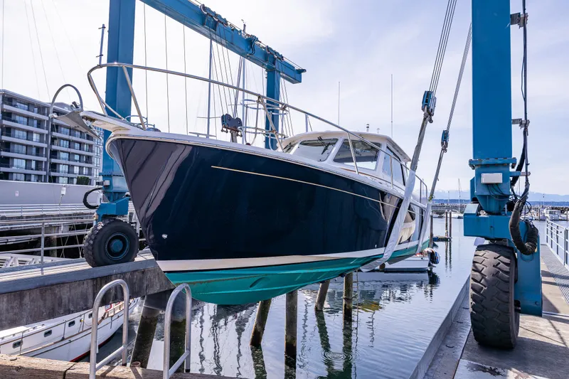 Slide: The Image of 2013 Back Cove 37 yacht in dry dock, marina background. - 11