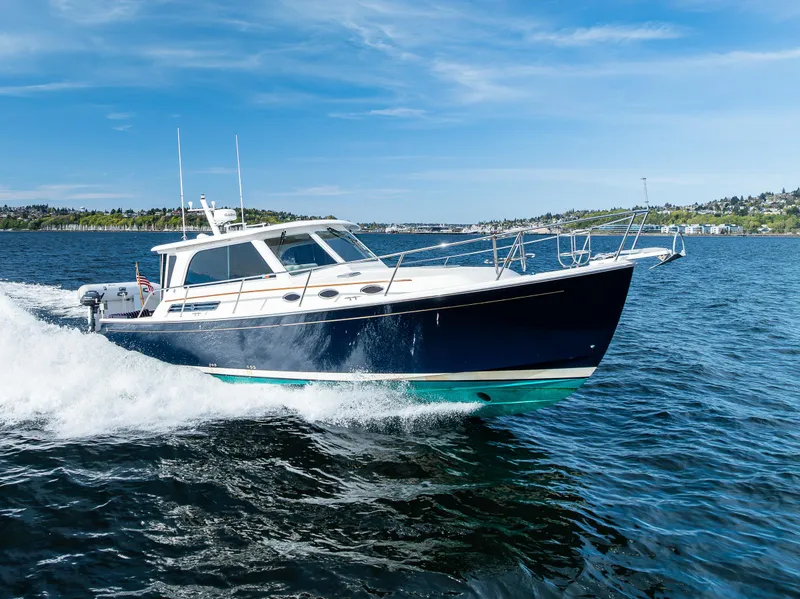 Slide: The Image of 2013 Back Cove 37 cruising on open water under a clear blue sky. - 15