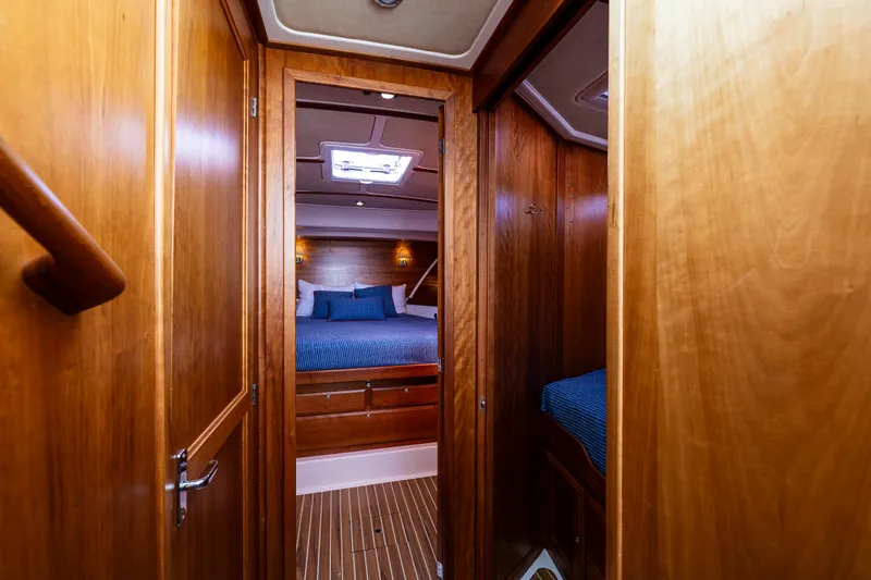 Slide: The Image of Interior of 2013 Back Cove 37 yacht, featuring cozy wooden cabin and blue bedding. - 18