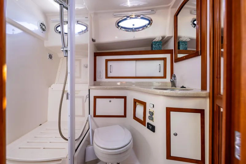 Slide: The Image of Luxurious bathroom in 2013 Back Cove 37 yacht with modern fixtures and elegant wood accents. - 21