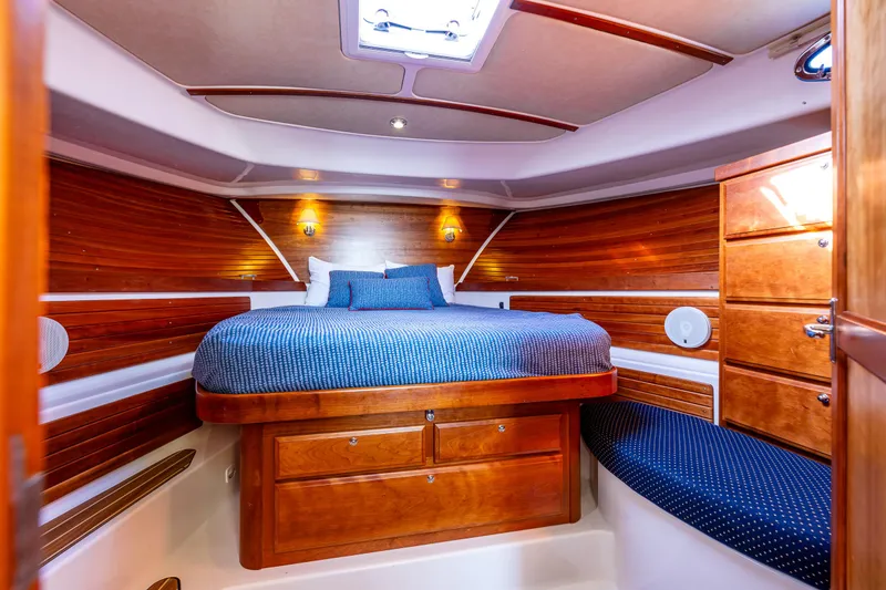 Slide: The Image of Luxurious cabin interior of 2013 Back Cove 37 yacht with wood finish and cozy bedding. - 23