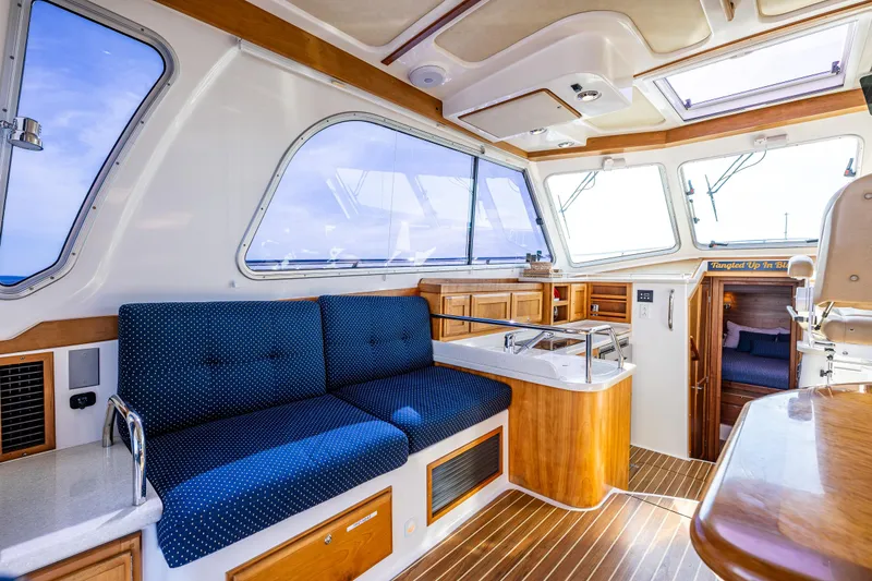 Slide: The Image of Interior of a 2013 Back Cove 37 yacht with blue seating and wooden accents. - 26