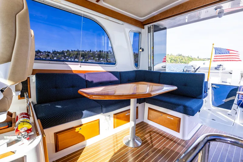 Slide: The Image of Interior of 2013 Back Cove 37 yacht with seating, table, and scenic window view. - 28