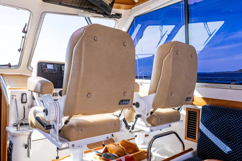 Slide: The Image of Interior of 2013 Back Cove 37 boat with two beige captain chairs. - 32