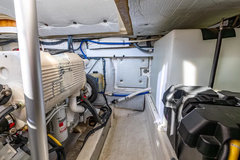 Slide: The Image of Engine room of 2013 Back Cove 37 boat, showcasing mechanical components and storage. - 38