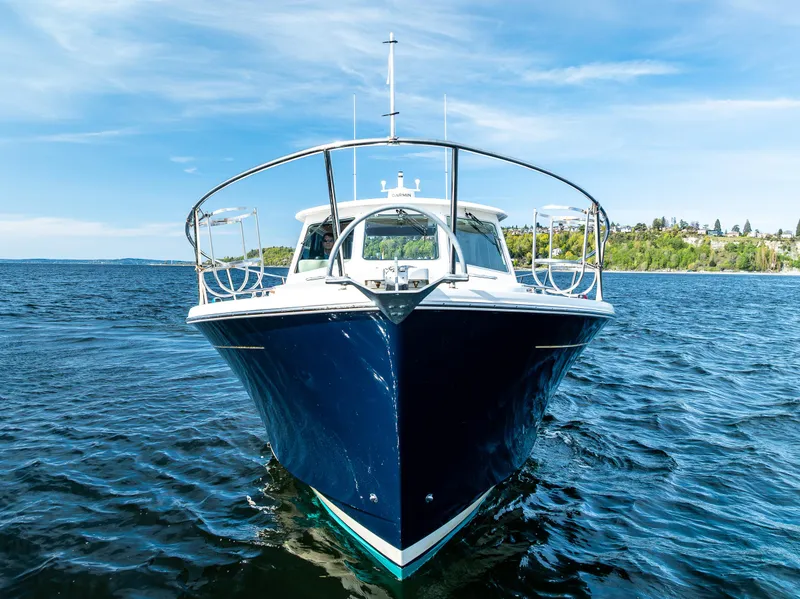 Slide: The Image of 2013 Back Cove 37 boat on open water under clear blue sky. - 4