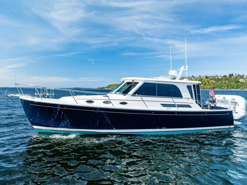 Slide: The Image of 2013 Back Cove 37 yacht cruising on a sunny day with clear blue skies. - 7