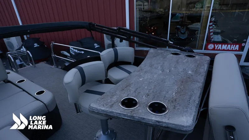 Slide: The Image of 2022 Barletta 24UE pontoon boat interior with seating and table at Long Lake Marina. - 13
