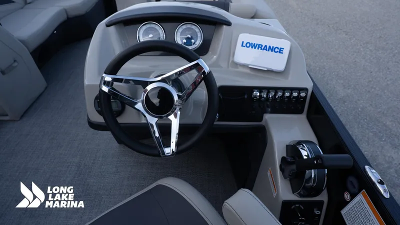 Slide: The Image of 2022 Barletta 24UE boat dashboard with steering wheel and Lowrance navigation system. - 17