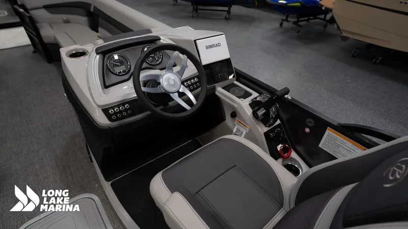 Slide: The Image of 2025 Barletta C24M boat dashboard with steering wheel and controls at Long Lake Marina. - 11
