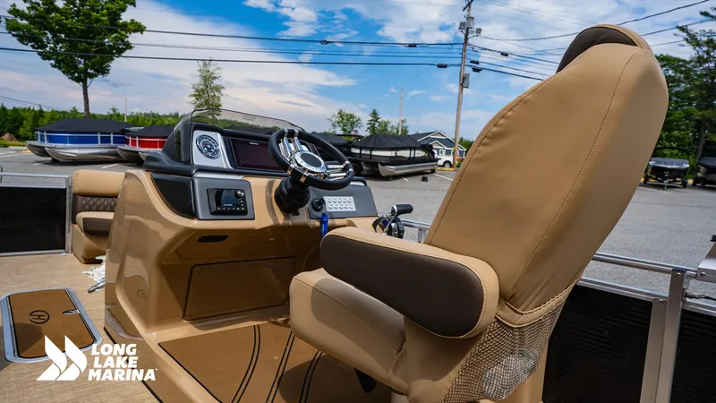 Slide: The Image of 2022 Harris Solstice boat interior with steering wheel and dashboard at Long Lake Marina. - 11