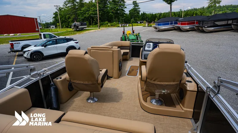 Slide: The Image of 2022 Harris Solstice pontoon boat interior at Long Lake Marina, featuring tan seating and dashboard. - 4