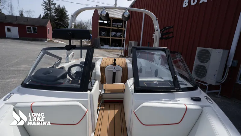 Slide: The Image of 2025 Nautique 200 boat at Long Lake Marina, featuring sleek design and modern interior. - 10