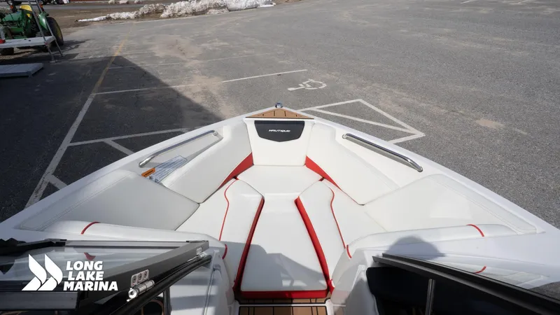 Slide: The Image of 2025 Nautique 200 boat interior with white and red seating at Long Lake Marina. - 11