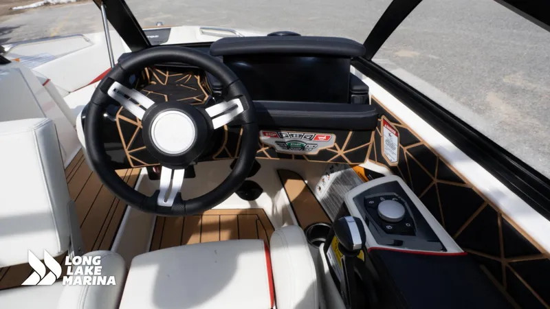 Slide: The Image of 2025 Nautique 200 boat interior with modern steering wheel and control panel. - 12