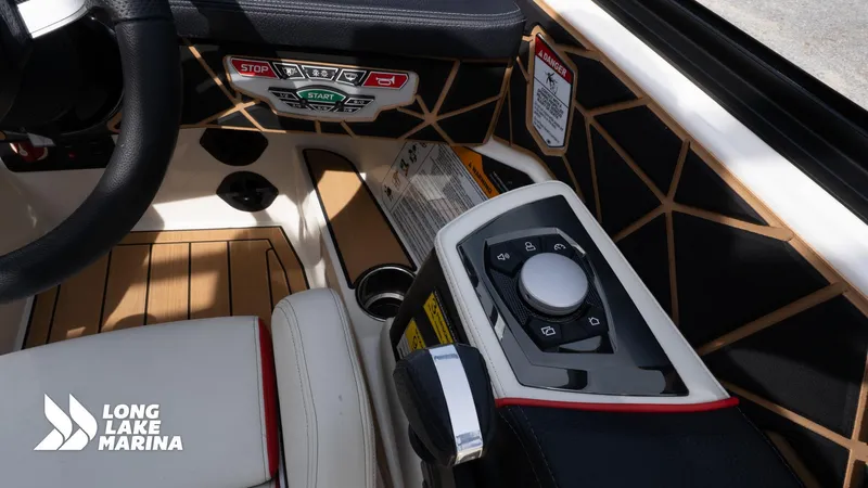 Slide: The Image of 2025 Nautique 200 boat interior with control panel and steering wheel at Long Lake Marina. - 13