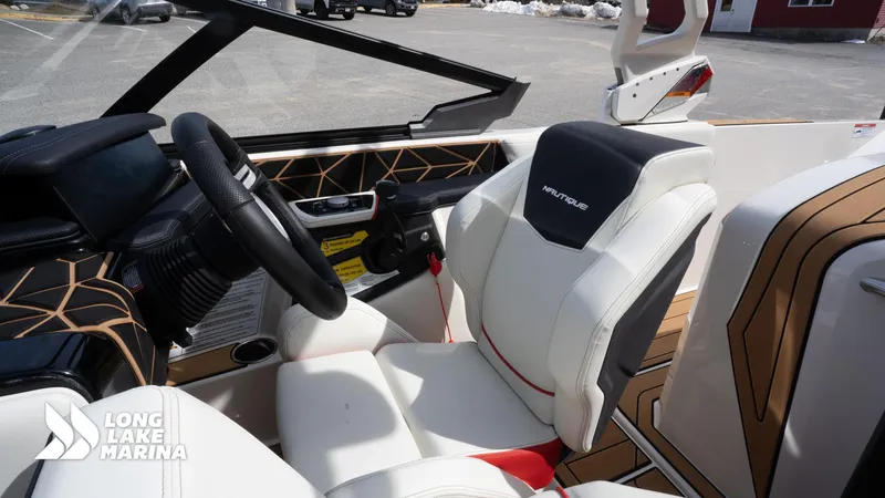 Slide: The Image of 2025 Nautique 200 boat interior with modern steering and comfortable seating at Long Lake Marina. - 14