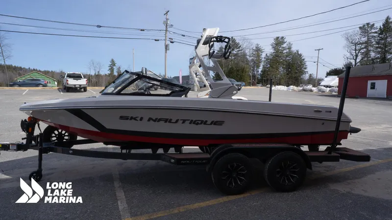 Slide: The Image of 2025 Nautique 200 ski boat on trailer at Long Lake Marina parking lot. - 5