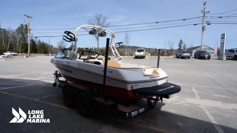 Slide: The Image of 2025 Nautique 200 boat on trailer at Long Lake Marina parking lot. - 6