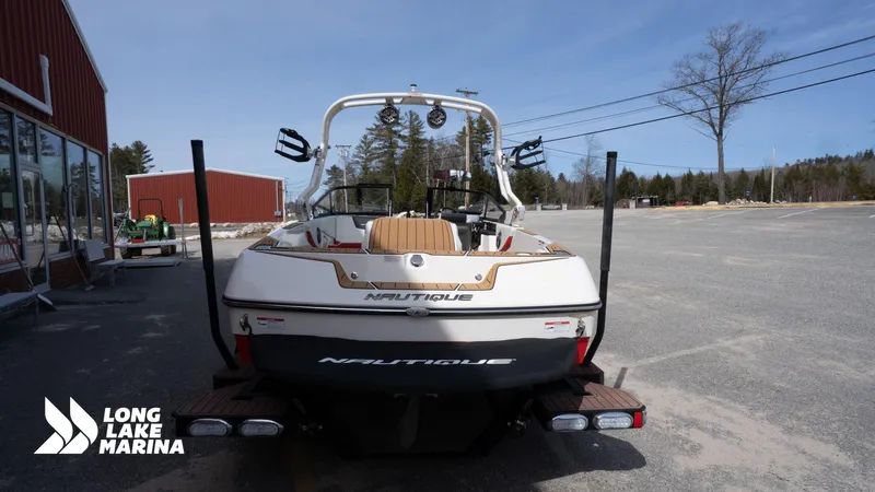 Slide: The Image of 2025 Nautique 200 boat at Long Lake Marina, rear view in parking lot. - 7