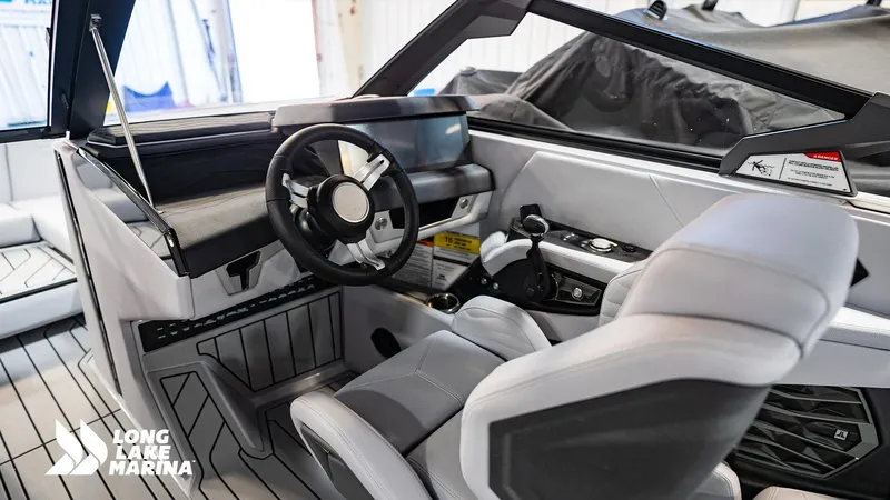 Slide: The Image of Interior of 2025 Nautique G23 boat with modern steering and controls at Long Lake Marina. - 4