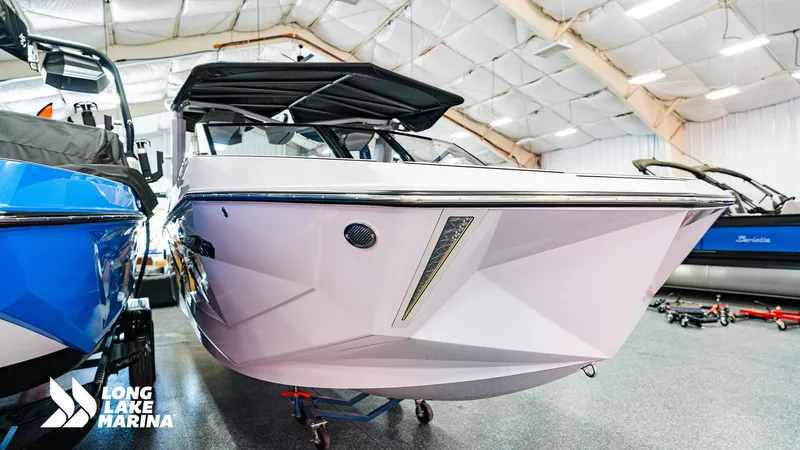 Slide: The Image of 2025 Nautique G23 boat displayed indoors at Long Lake Marina. - 5