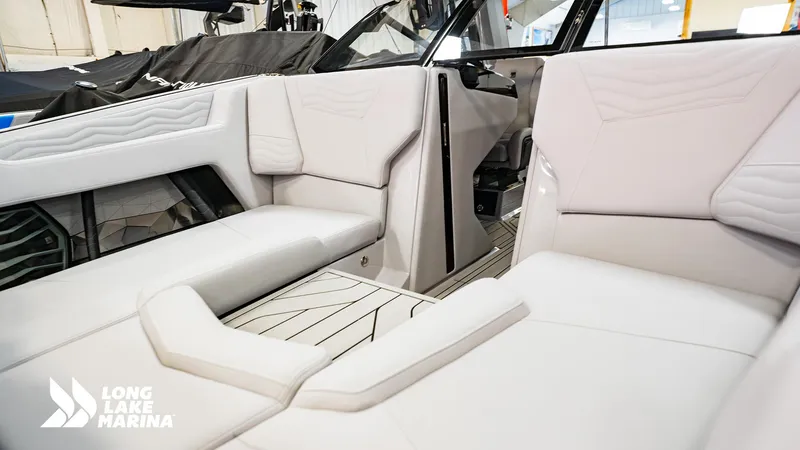 Slide: The Image of 2025 Nautique G23 boat interior with luxurious white seating at Long Lake Marina. - 7
