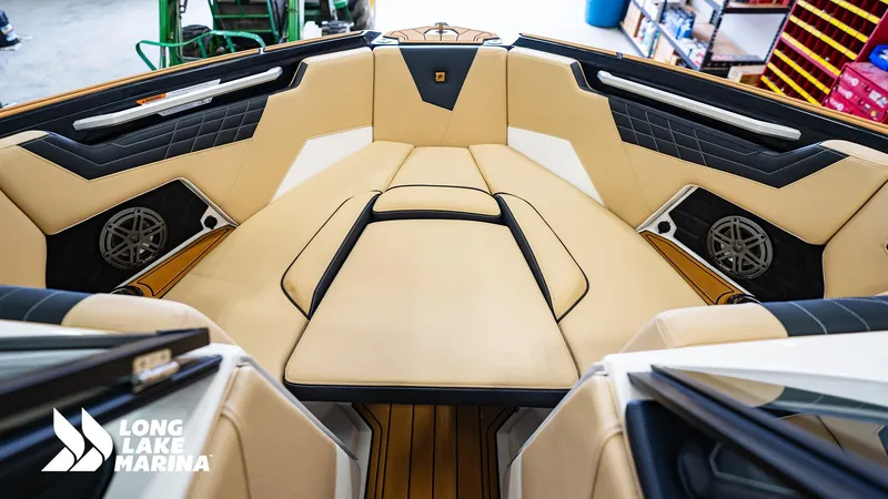 Slide: The Image of 2024 Nautique S21 boat interior with tan and black seating at Long Lake Marina. - 3