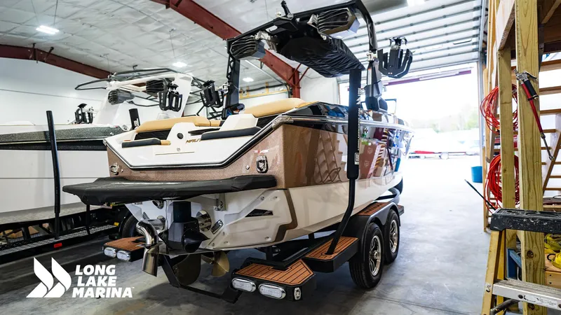 Slide: The Image of 2024 Nautique S21 boat in a marina showroom, featuring sleek design and modern amenities. - 5