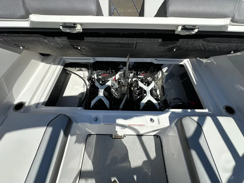 Slide: The Image of 2024 Yamaha Boats AR250 engine compartment with dual engines, open hatch view. - 12