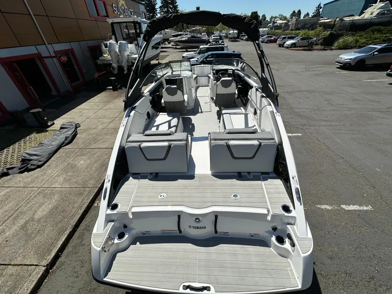 Slide: The Image of 2024 Yamaha Boats AR250, sleek design, spacious interior, parked outdoors. - 14