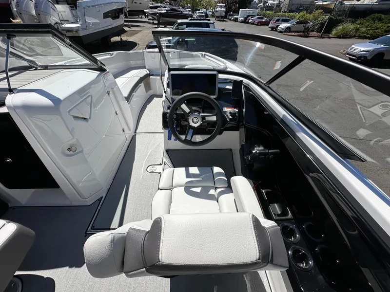 Slide: The Image of 2024 Yamaha Boats AR250 cockpit with modern steering and seating. - 18