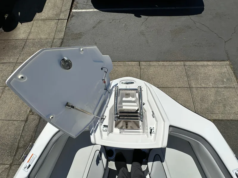Slide: The Image of 2024 Yamaha AR250 boat bow with open storage compartment, showcasing sleek design and functionality. - 21