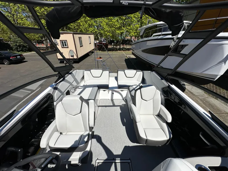 Slide: The Image of 2024 Yamaha Boats AR250 interior with white seating and sleek design. - 23