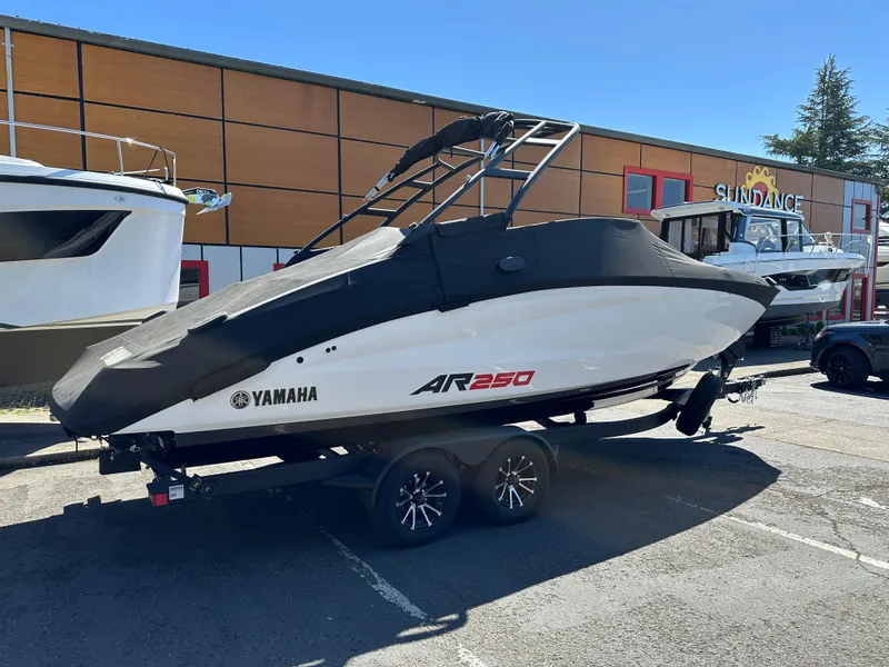Slide: The Image of 2024 Yamaha Boats AR250 on trailer, parked outdoors, side view. - 4