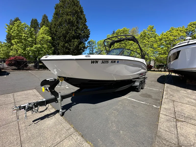 Slide: The Image of 2024 Yamaha Boats AR250 on trailer, parked outdoors under clear blue sky. - 7