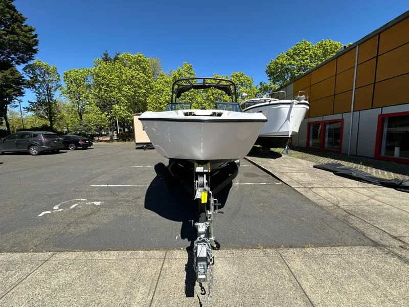 Slide: The Image of 2024 Yamaha Boats AR250 on trailer in parking lot, surrounded by trees and buildings. - 9