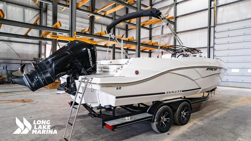 Slide: The Image of 2022 Starcraft SVX231 boat in a marina warehouse, featuring a Mercury outboard motor. - 5