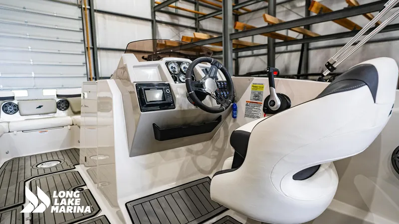 Slide: The Image of 2022 Starcraft SVX231 boat interior with steering wheel and controls at Long Lake Marina. - 9