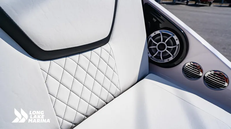 Slide: The Image of 2025 Yamaha Boats 222S interior with diamond-stitched seating and speaker system, Long Lake Marina logo. - 11