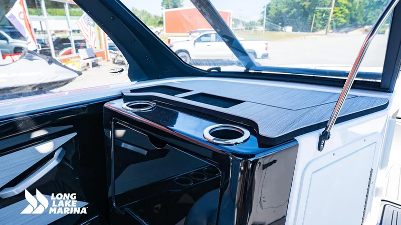 Slide: The Image of 2025 Yamaha Boats 222S interior with sleek design and cup holders at Long Lake Marina. - 6