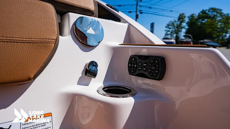 Slide: The Image of 2025 Yamaha Boats 252SD interior detail with control panel and cup holder. - 13