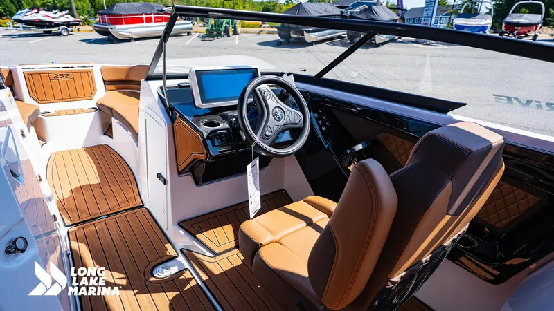 Slide: The Image of 2025 Yamaha Boats 252SD interior with modern dashboard and seating at Long Lake Marina. - 4