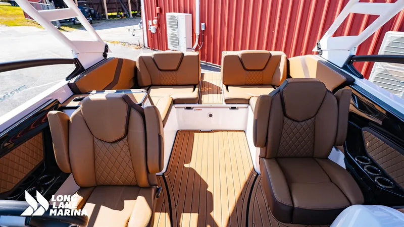 Slide: The Image of 2025 Yamaha Boats 252SD interior with luxurious brown seating and wood-style flooring. - 5