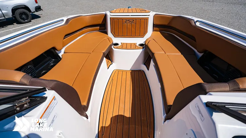 Slide: The Image of 2025 Yamaha Boats 252SD interior with tan seating and wood accents at Long Lake Marina. - 9
