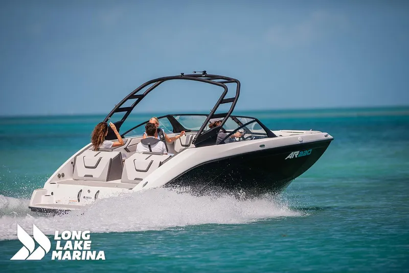 Slide: The Image of 2025 Yamaha AR220 boat cruising on clear blue water near Long Lake Marina. - 3